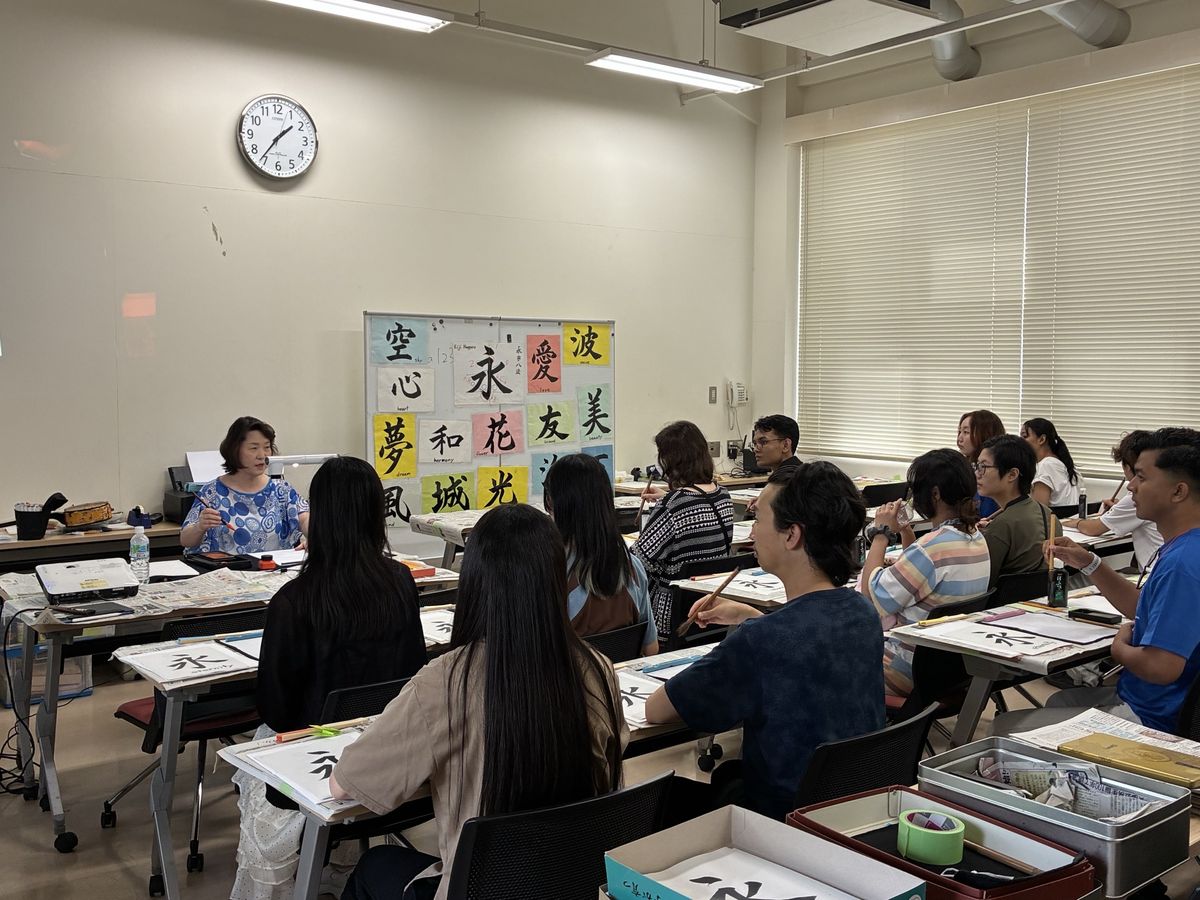 教室で書道を指導するようす